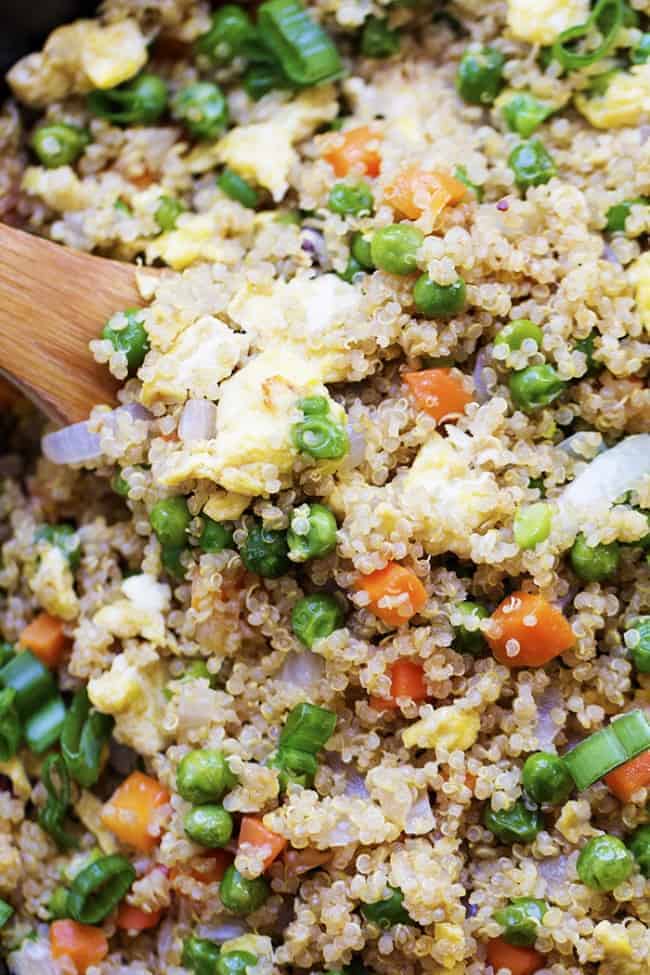 quinoa fried rice close up with wooden spoon.