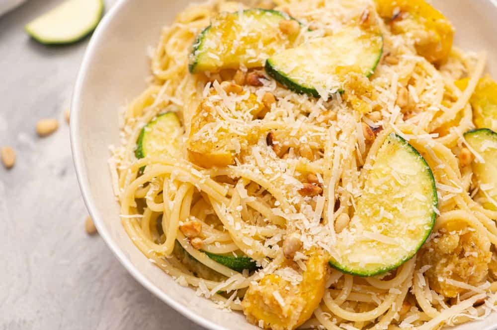 Summer squash lemon spaghetti in a white bowl.