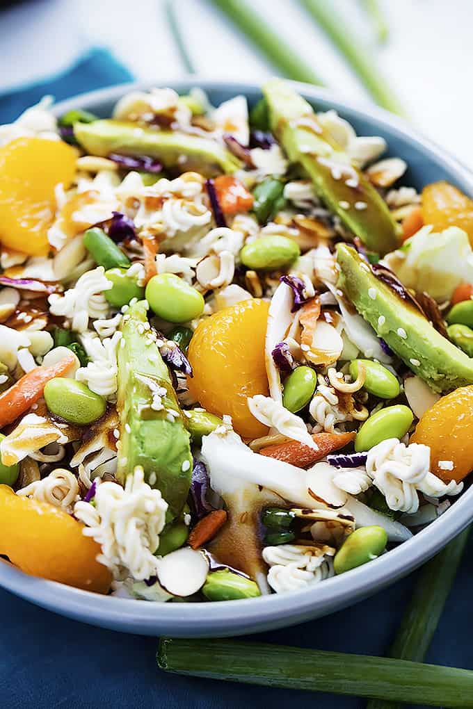 asian edamame ramen salad in a blue bowl.