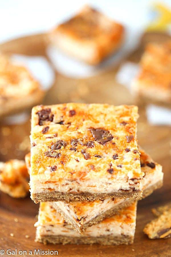 Butterfinger Cheesecake Bars in a stack.