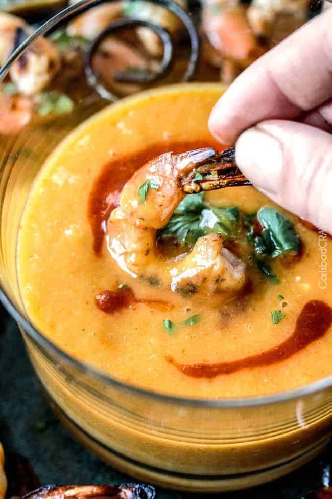 Dipping Coconut Honey Lime Shrimp into Mango Dip.