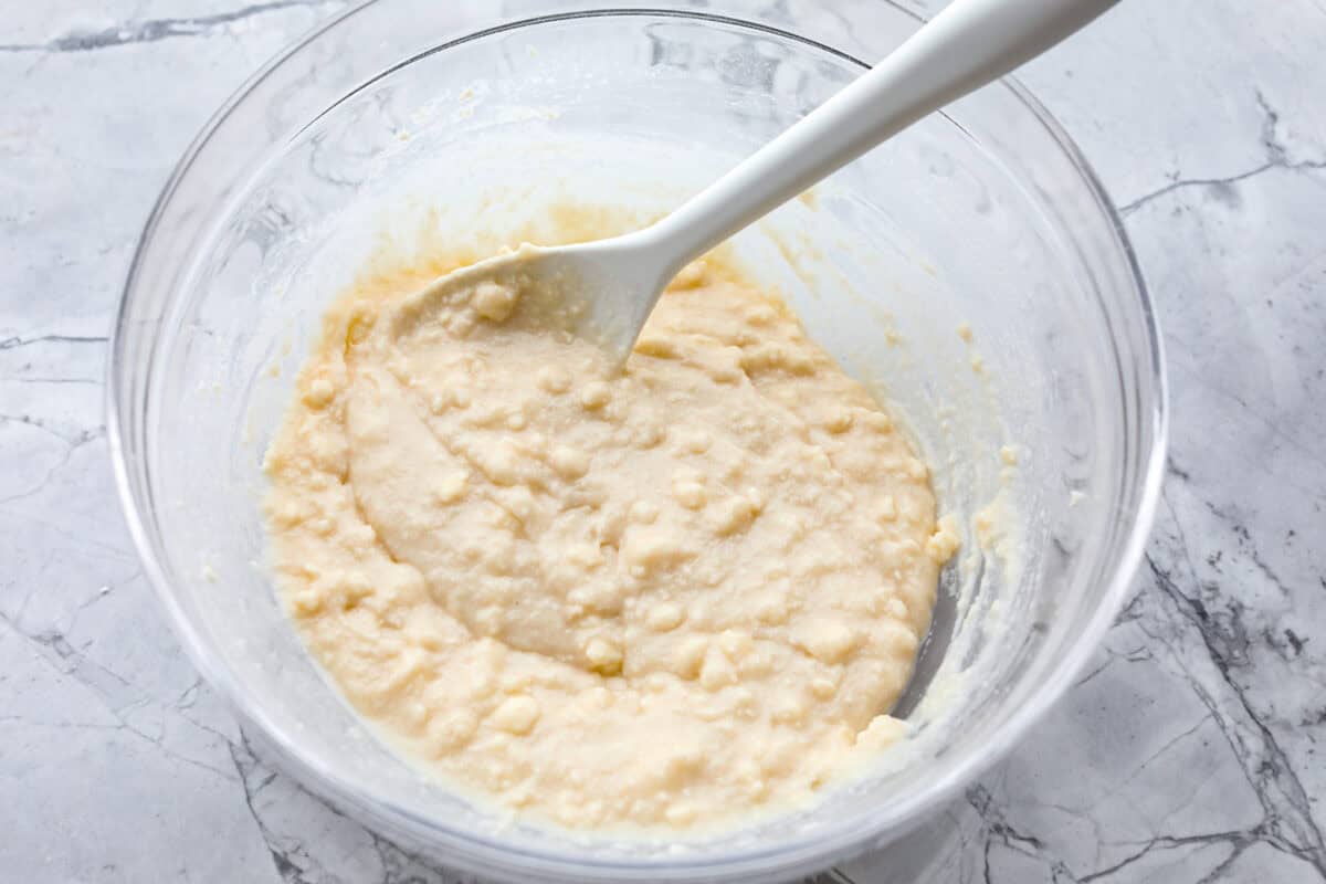 Overhead shot of dry ingredients and butter mixed with milk.