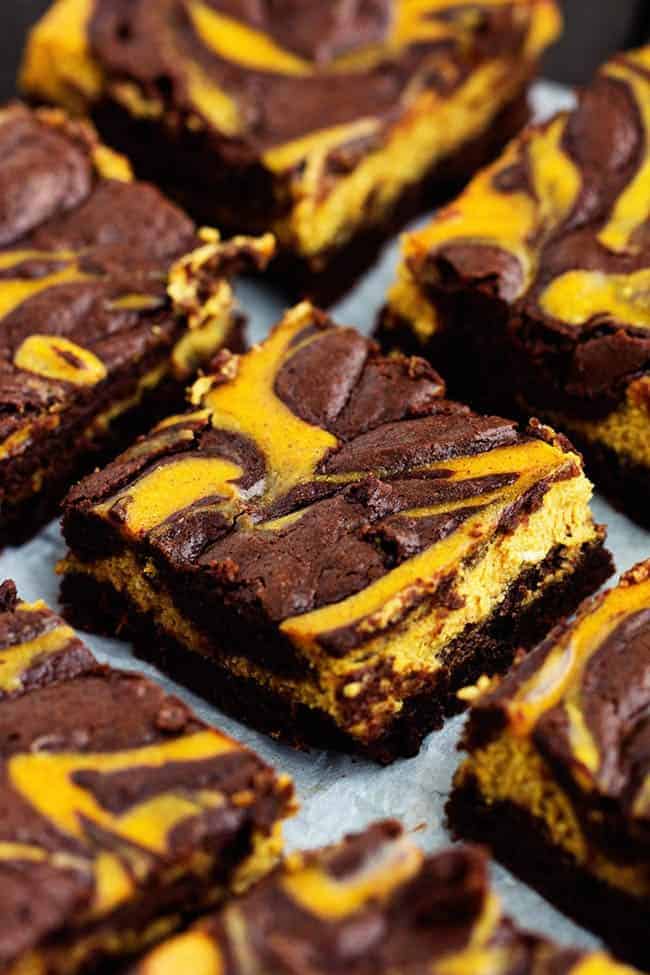 pumpkin cheesecake brownies cut on a tray.