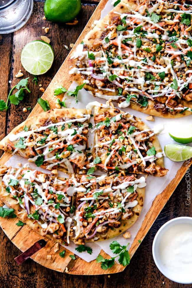 Thai Chicken Flatbread Pizza areal view on a wooden board.