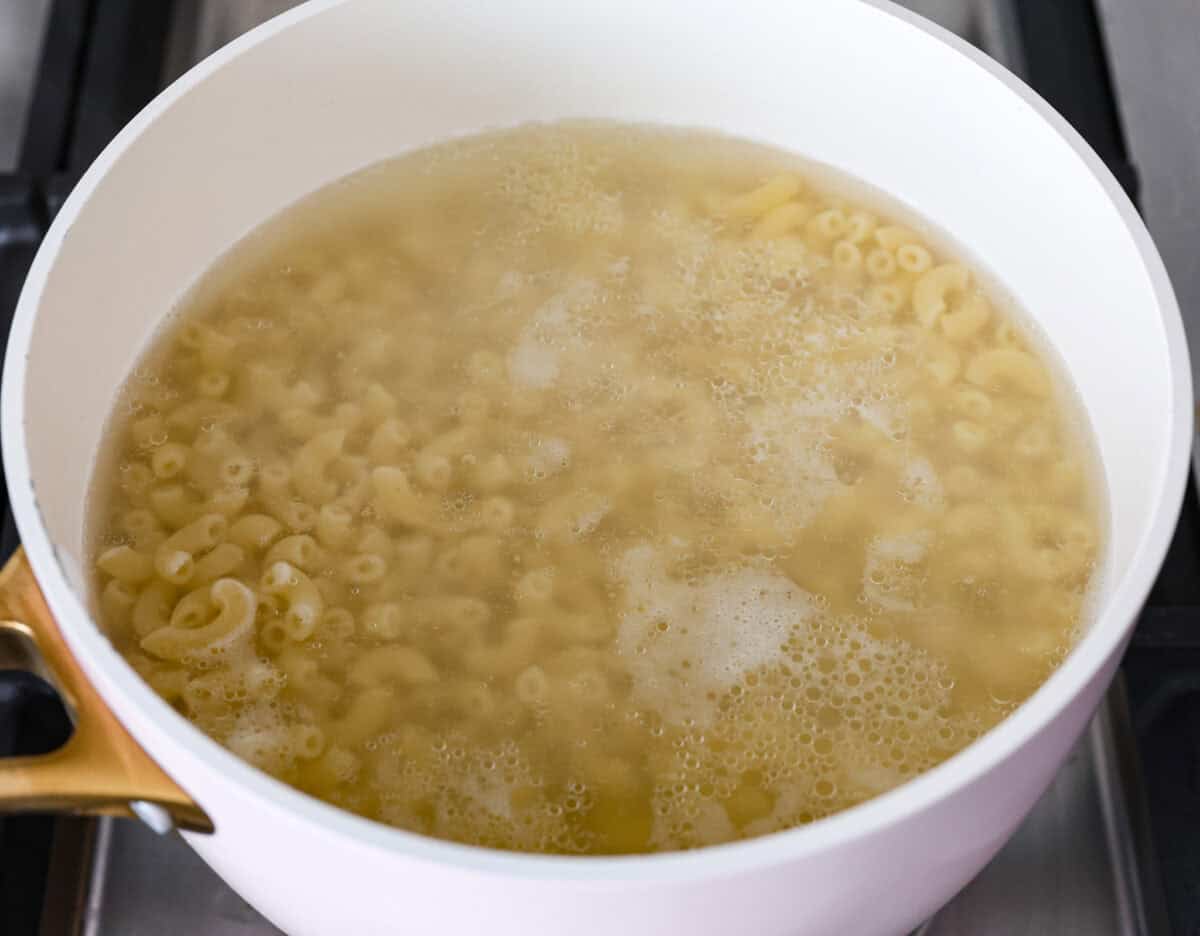 Angle shot of pasta cooking in a pot on the stove. 