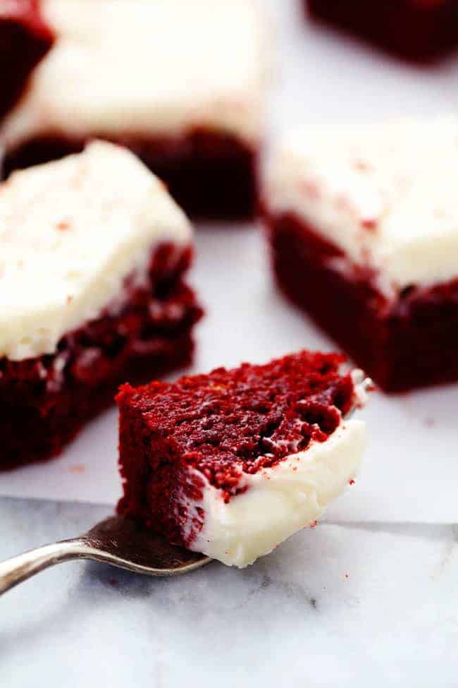 Red velvet brownies with a slice taken out using a fork. 