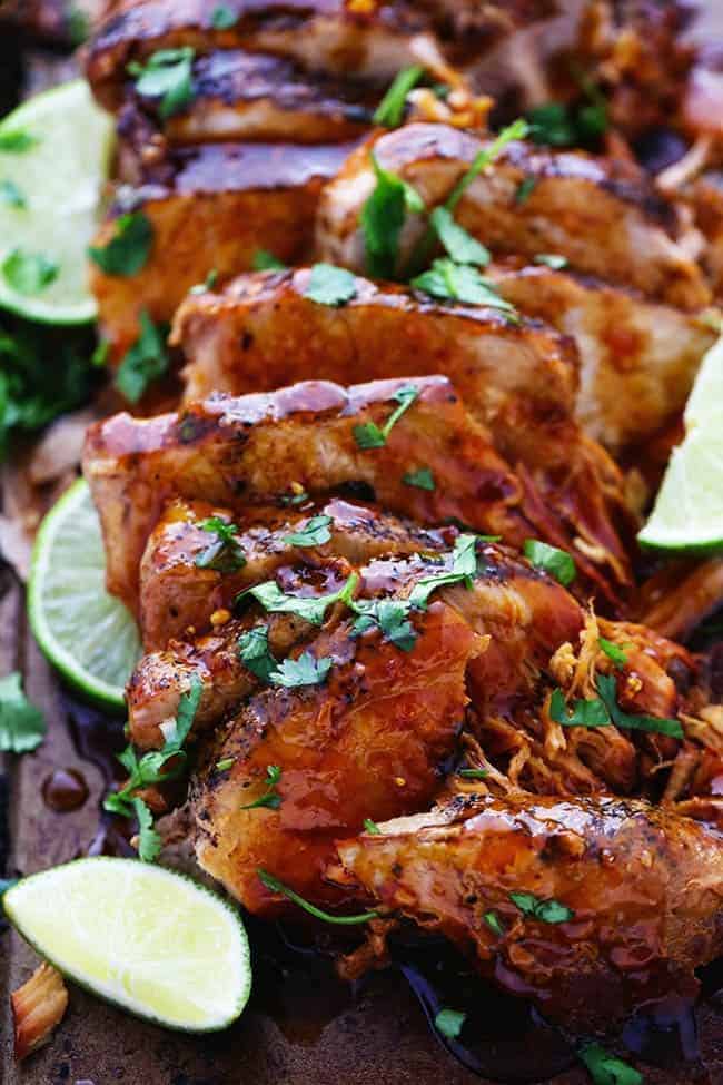 Slow cooker honey lime ginger pork with fresh-cut limes on the side.