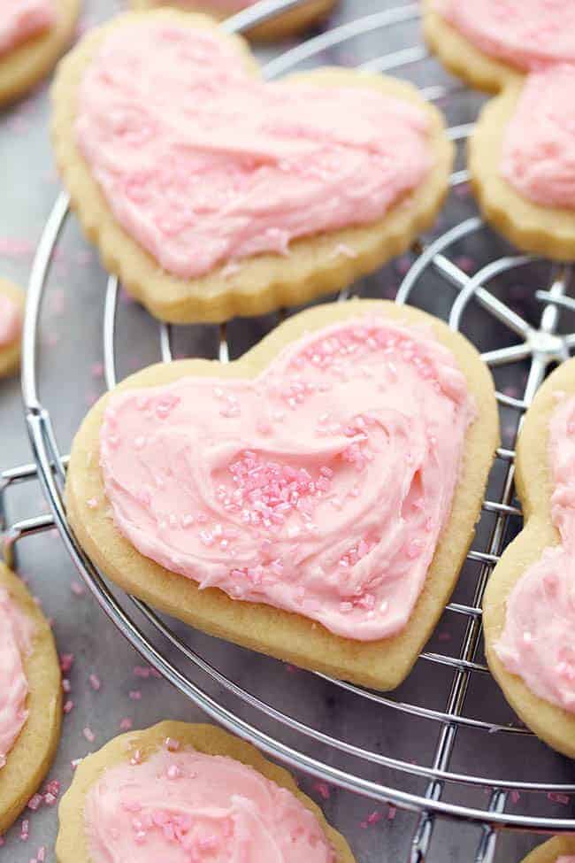 A zoomed in picture of a sugar cookie on a cooling rack.