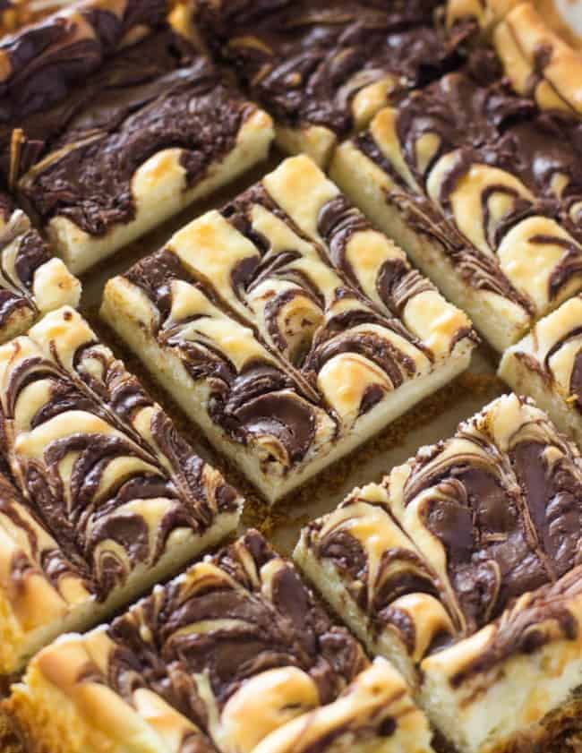 Nutella Swirl Cheesecake Bars sliced in 2 inch squares. 