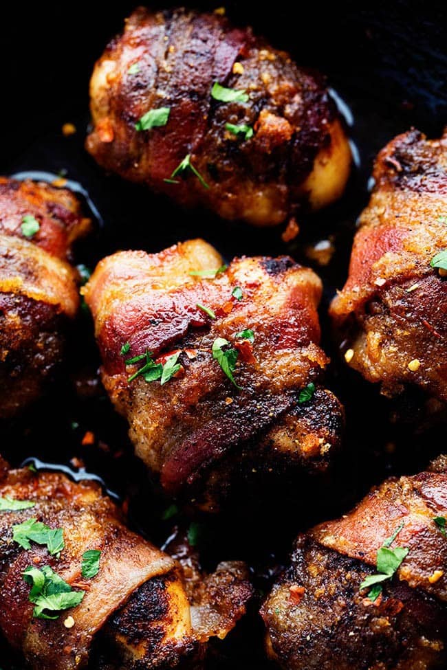 Overhead photo of sweet and spicy bacon wrapped chicken in a skillet.