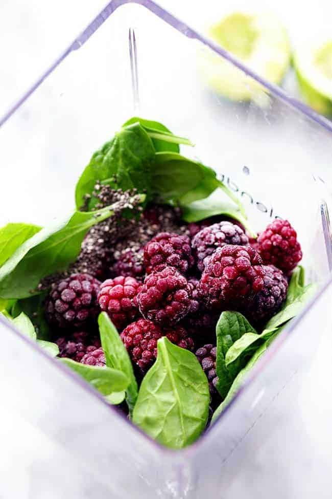 Fresh blackberries and spinach in a blender.