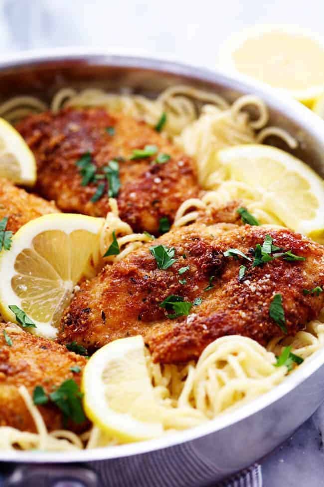 Crispy Parmesan Chicken with Creamy Lemon Garlic Pasta in a metal frying pan. 