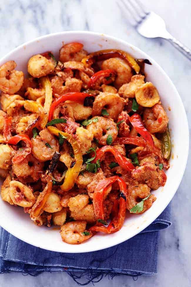 Creamy Shrimp Fajita Pasta Skillet in a white bowl with a metal fork. 