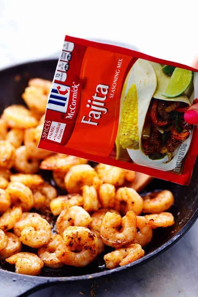 Creamy Shrimp Fajita Pasta Skillet in a black skillet with a packet of McCormick Fajita seasoning. 