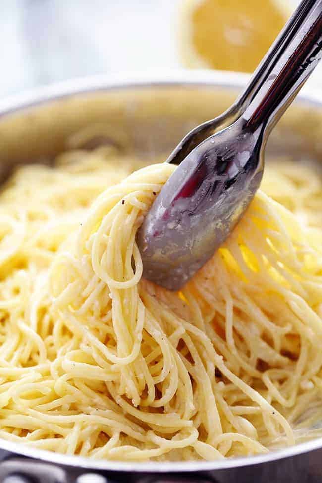 Creamy Lemon Garlic Pasta with a set of tongs. 