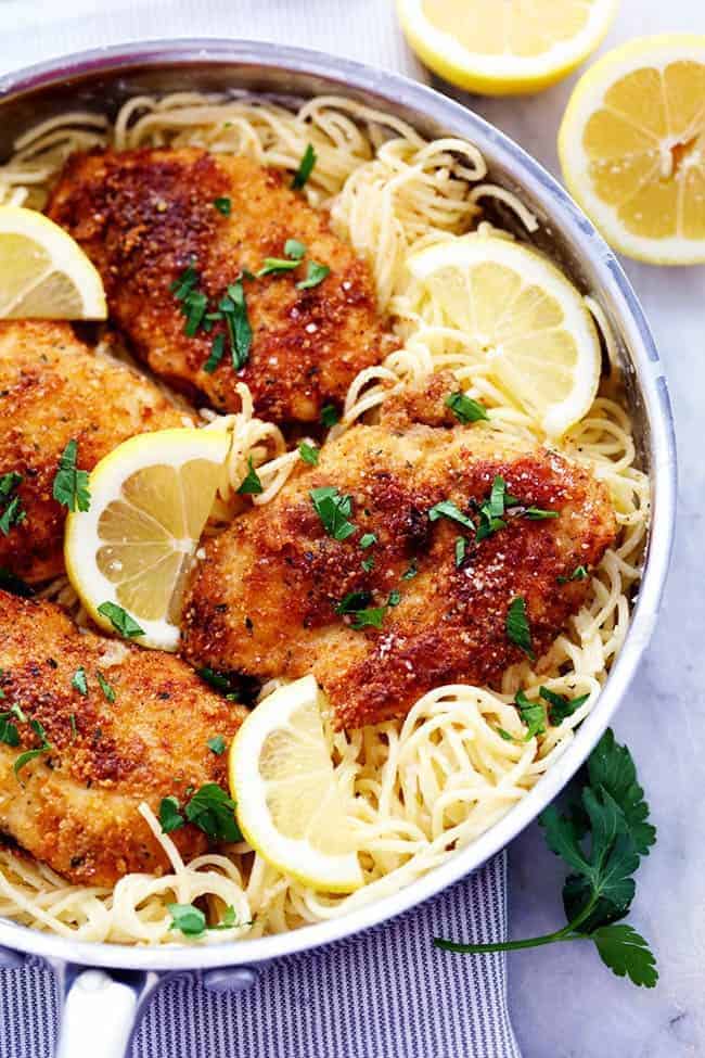 Crispy Parmesan Chicken with Creamy Lemon Garlic Pasta in a metal frying pan. 