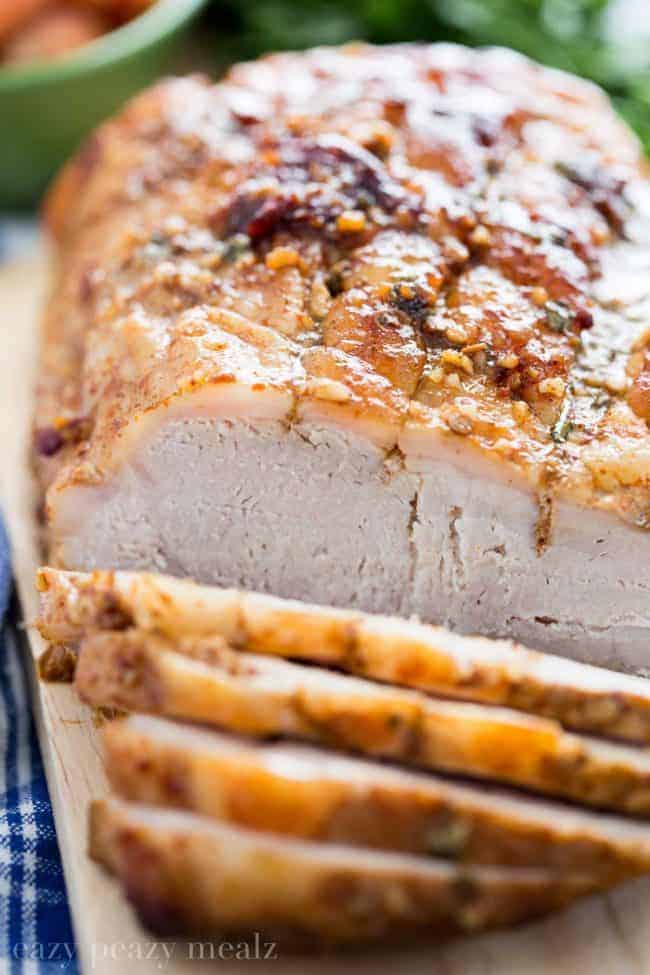 Honey Chipotle Pork Roast sliced and on a cutting board. 