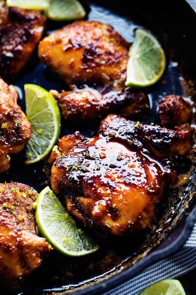 Skillet honey lime chicken in a large black skillet. 