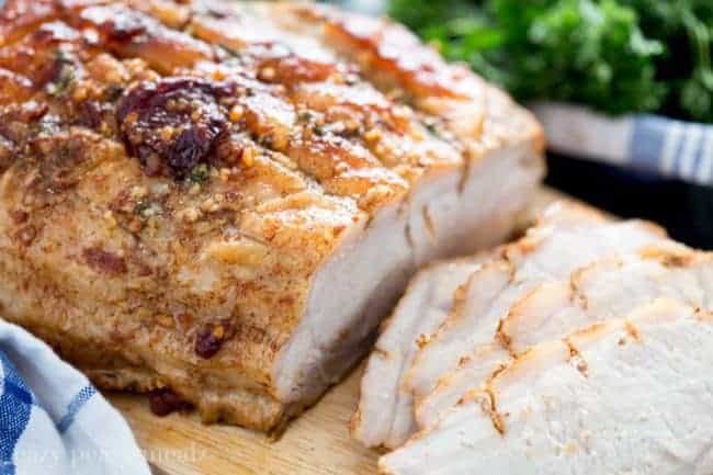 Sliced Honey Chipotle Pork Roast on a wooden cutting board. 