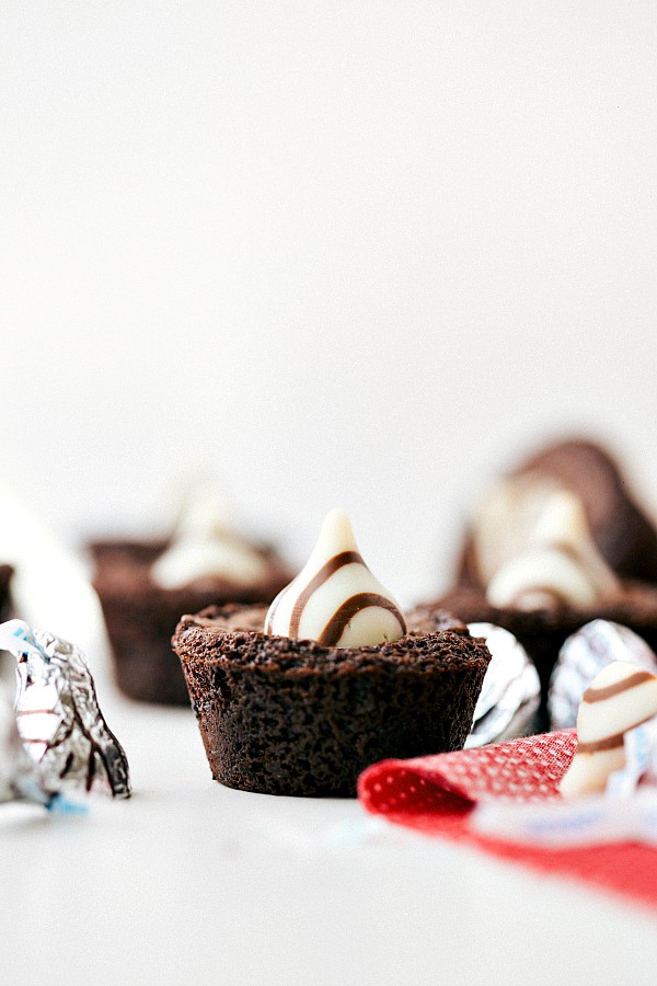 Chocolate Filled Mini Brownie Bites with Hersey's Hugs on top and on the table. 