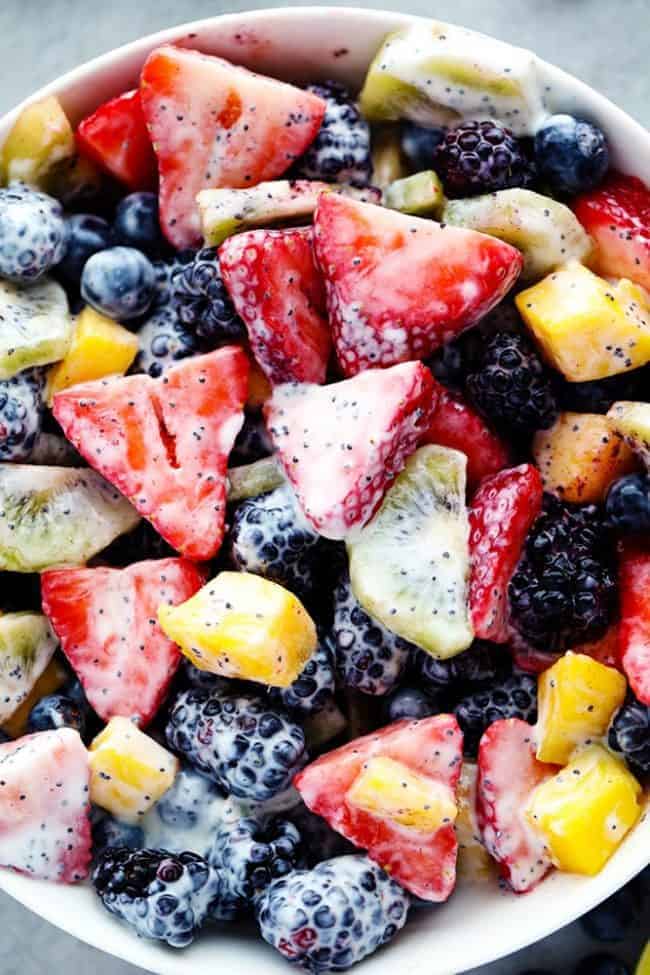 Creamy Poppyseed Fruit Salad in a white bowl. 