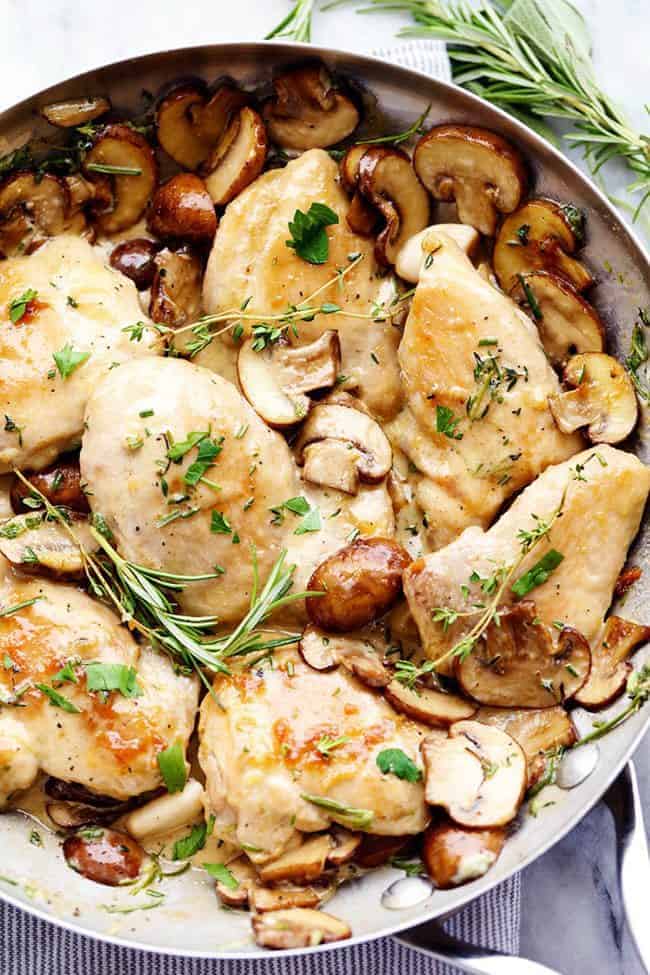 Creamy Garlic Herb Mushroom Chicken in a metal frying pan. 