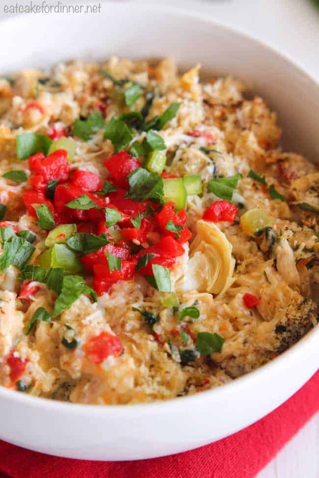 Creamy Spinach and Artichoke Chicken Quinoa in a white bowl. 