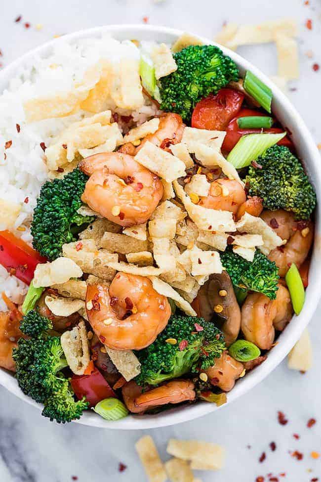 Wonton Shrimp Stirfry in a white bowl over white rice. 