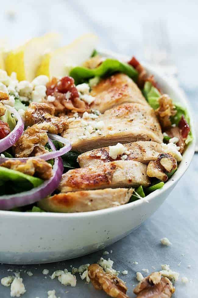 Grilled Chicken, Bacon, and Pear Salad with Poppyseed dressing in a white bowl. 