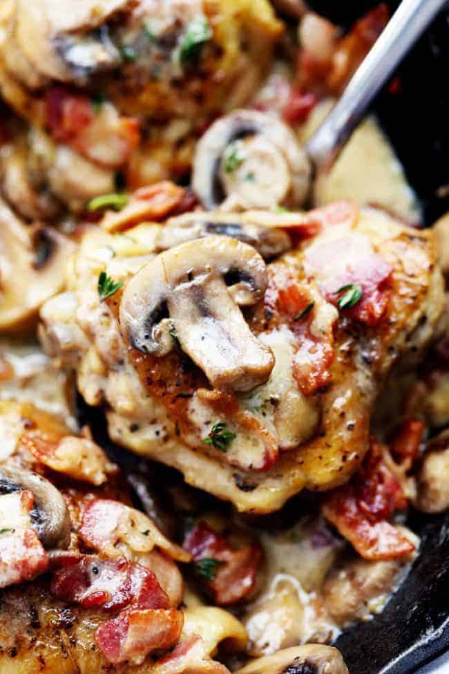 Close up of Creamy Bacon Mushroom Thyme Chicken with a metal spoon. 