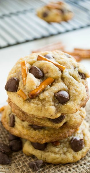 Brown butter toffee pretzel chocolate chip cookie stacked on top of each other.