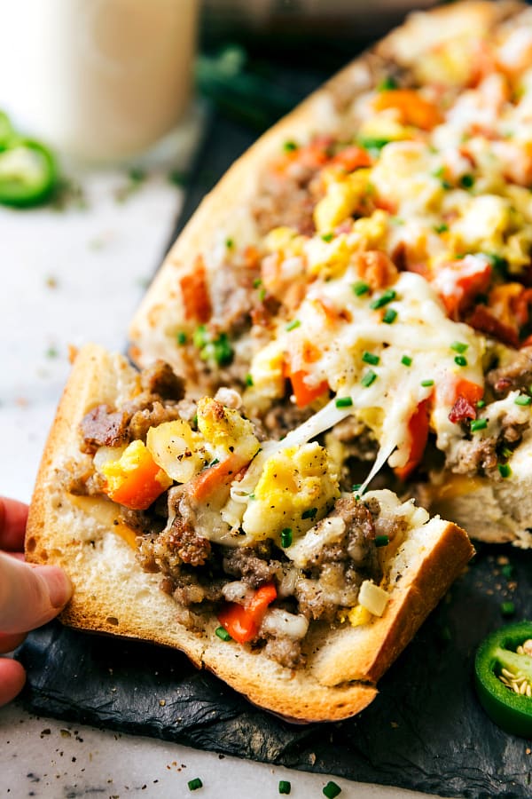 Sausage stuffed French bread bowl with a slice it cut off on the end. 