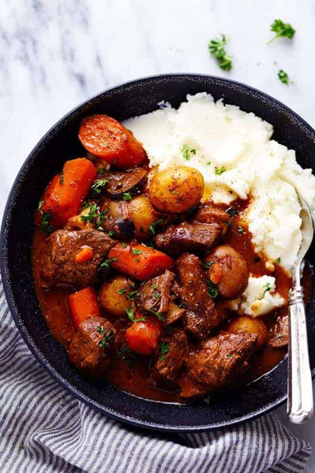 slow Cooker Beef Bourguignon with mashed potatoes on a plate 