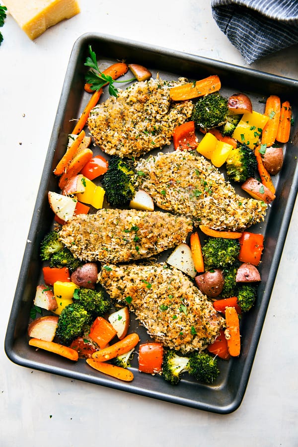 One Pan Crispy Walnut Herb Chicken and Vegetables in a baking tray.