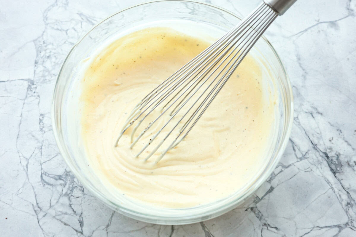 Overhead shot of bowl dressing with a whisk sticking out.