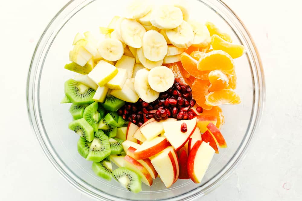 Winter Fruit Salad with bananas apples, oranges kiwi and pomegranates. 