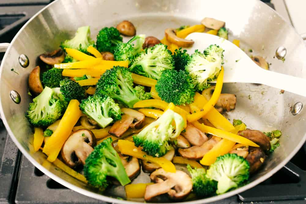 Sauteing mushrooms, peppers, and broccoli. 