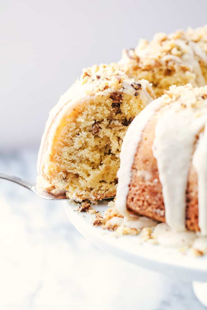 Glazed Walnut Butter Cake with one slice being pulled out.