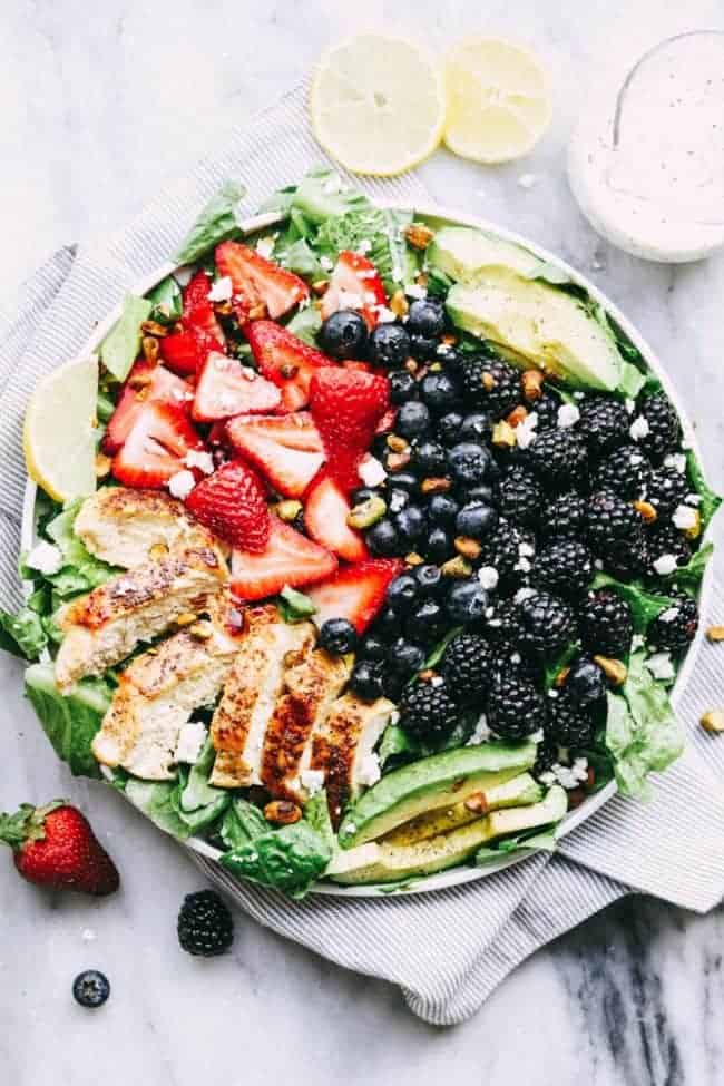 Finished Triple Berry Chicken Avocado Salad with a Creamy Lemon Poppyseed Dressing in a bowl.