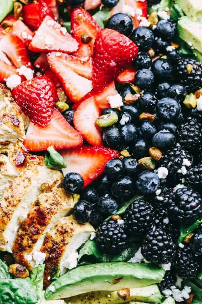 Triple Berry Chicken Avocado Salad with close up on strawberries, blueberries, blackberries and chicken.