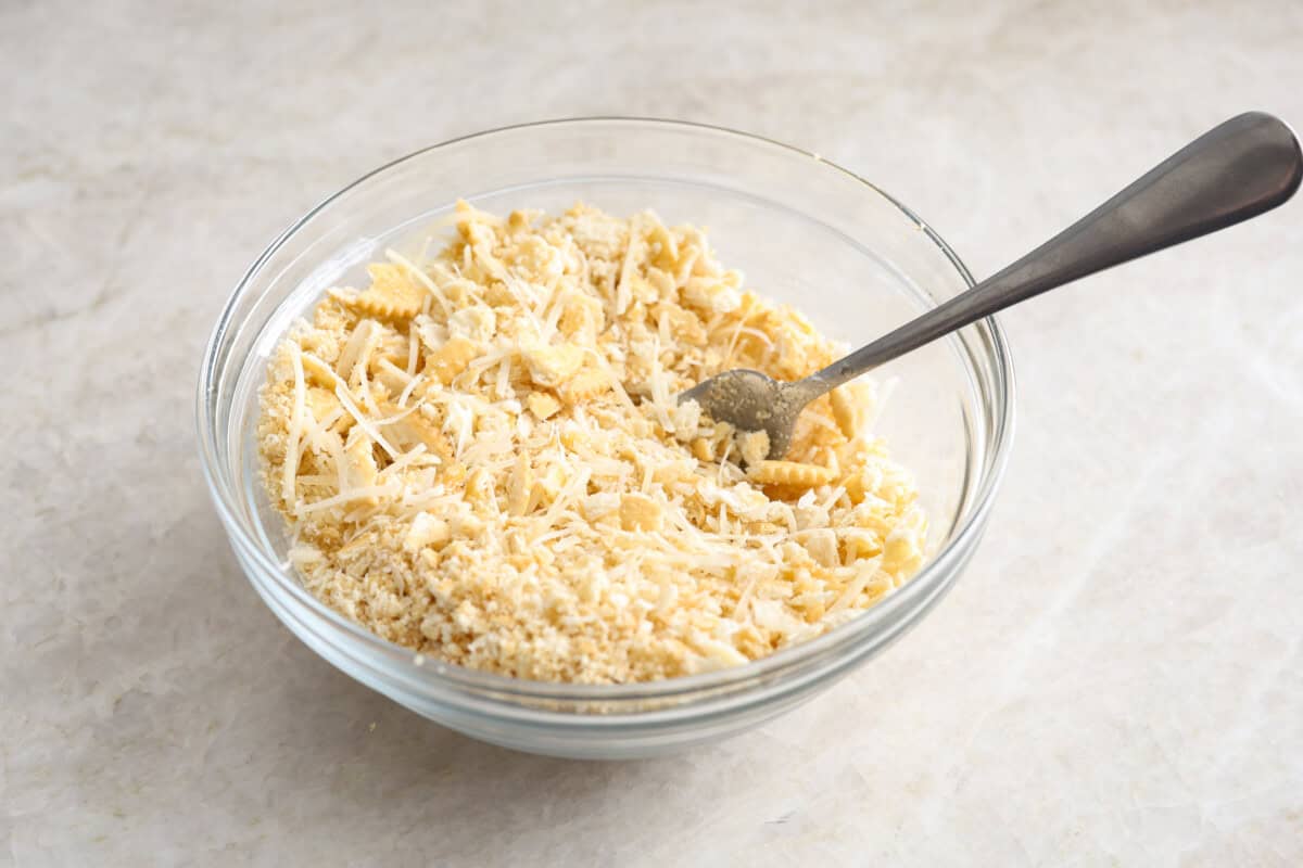 Overhead shot of the crushed Ritz crackers butter and cheese in a bowl. 