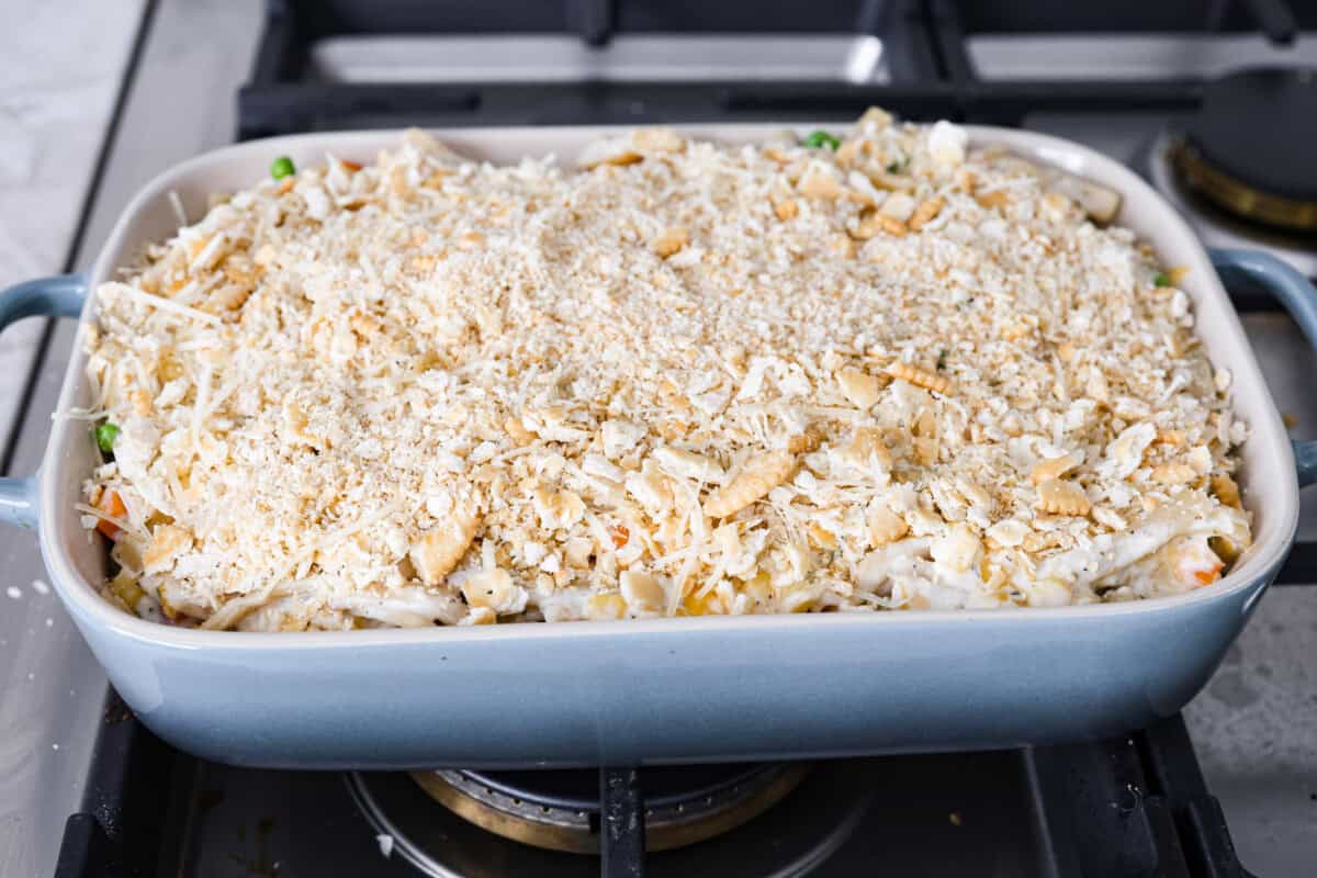 Angle shot of the creamy chicken noodle casserole ready to be topped with aluminum foil and into the oven.