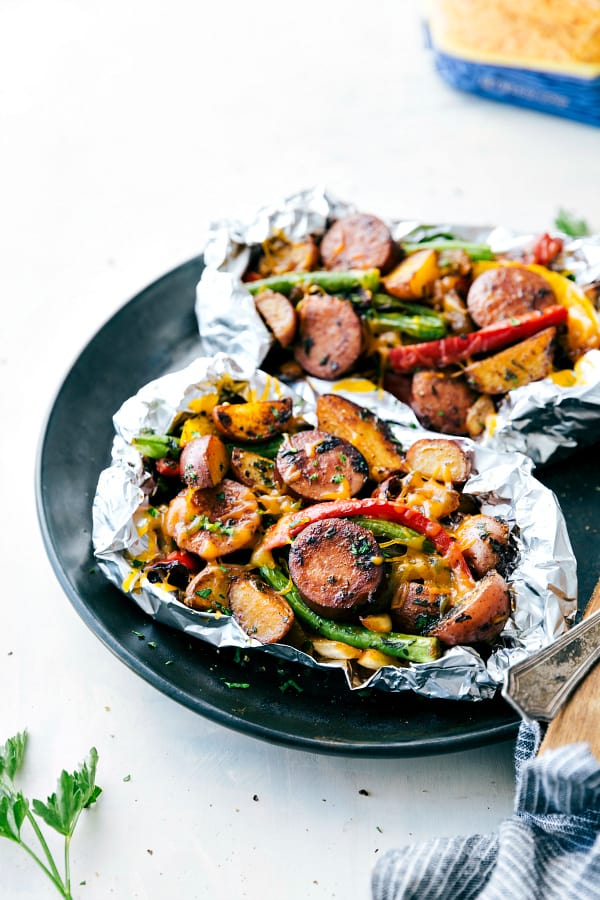 Cheesy Sausage Potato Foil Packets on a black plate.