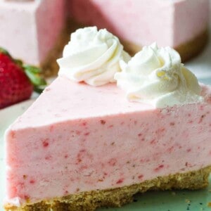 No Bake Frozen Strawberry Yogurt Pie! This frozen pie is perfect for warmer weather! No baking needed, and the pie itself is a creamy cool strawberry and cream flavor. Made with greek yogurt, real cream, and fresh strawberry puree! All on top of a pretzel crust.