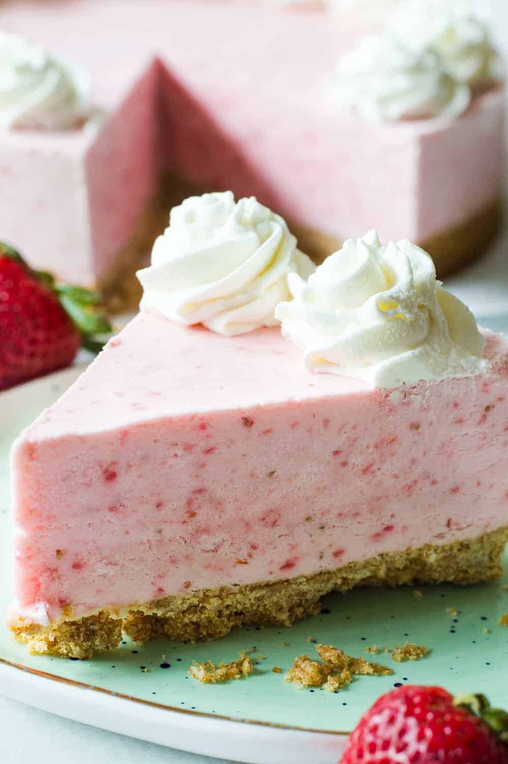 No Bake Frozen Strawberry Yogurt Pie! This frozen pie is perfect for warmer weather! No baking needed, and the pie itself is a creamy cool strawberry and cream flavor. Made with greek yogurt, real cream, and fresh strawberry puree! All on top of a pretzel crust.