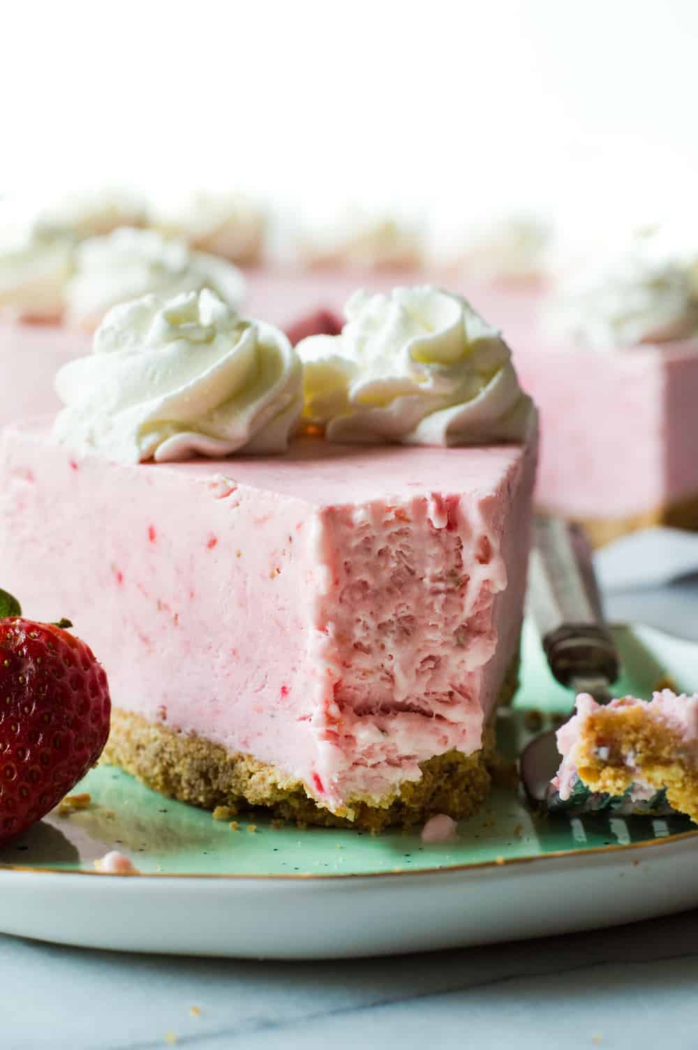 No Bake Frozen Strawberry Yogurt Pie on a green plate.