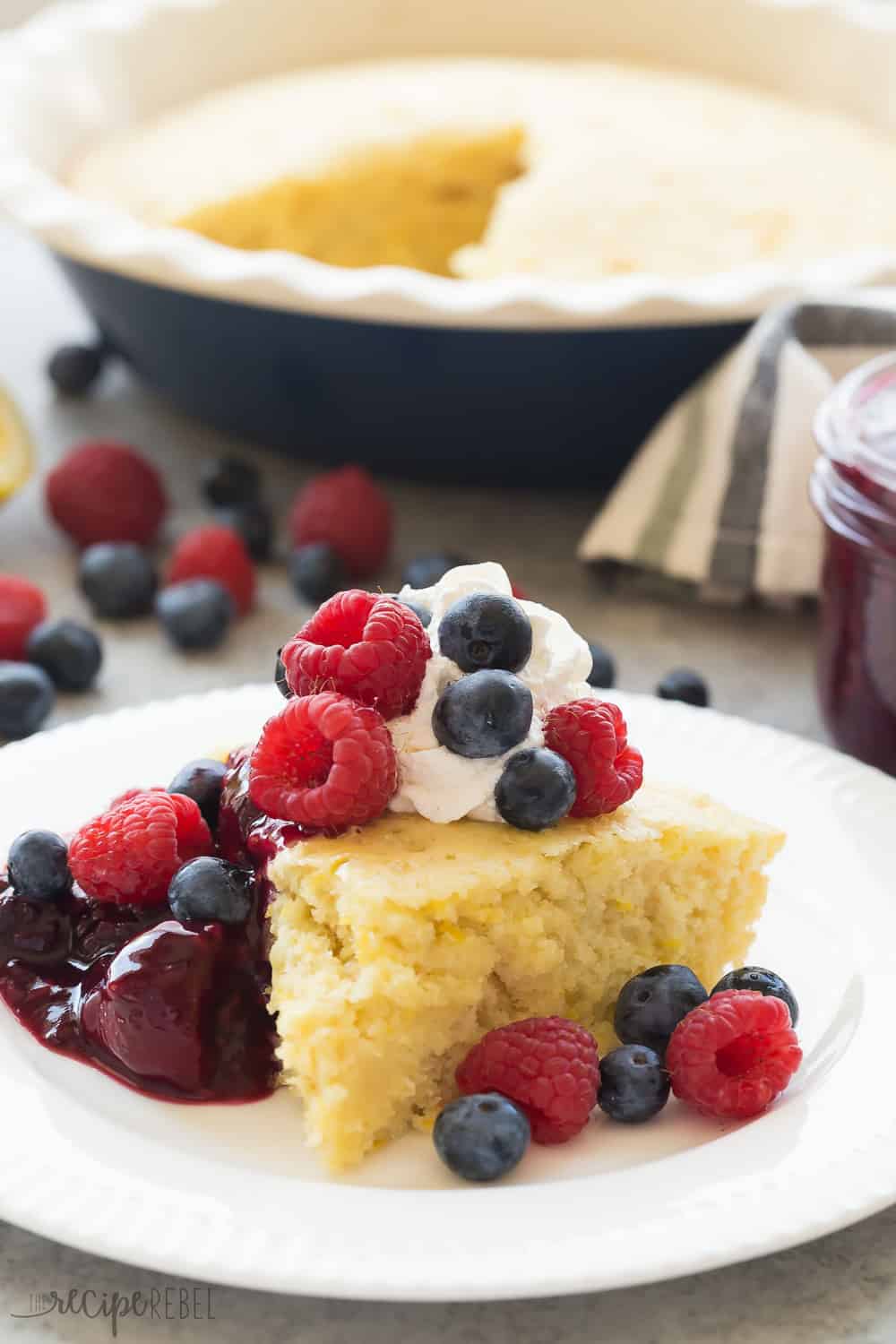 This Lemon Baked Pancake with Berry Sauce slice on a white plate.