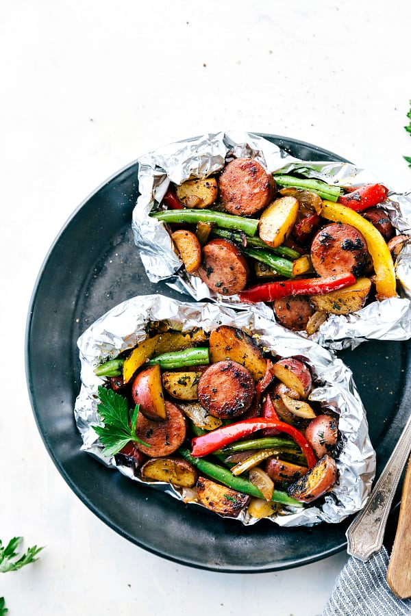 Cheesy Sausage Potato Foil Packets on a black plate.