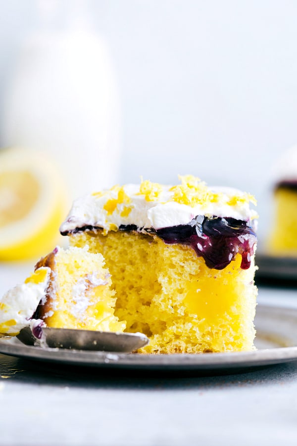 Slice of Lemon Blueberry Poke Cake on a plate.