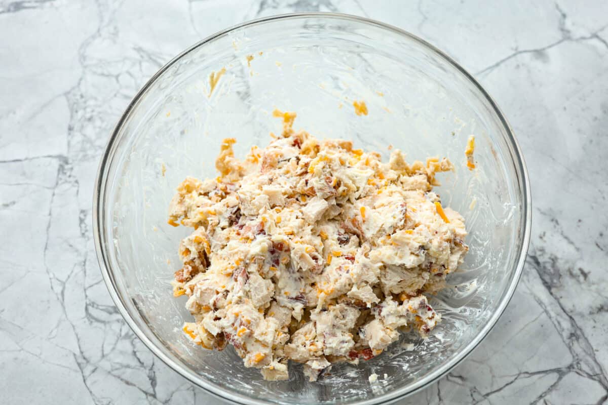 Overhead shot of chicken bacon ranch filling mixed together in a bowl. 